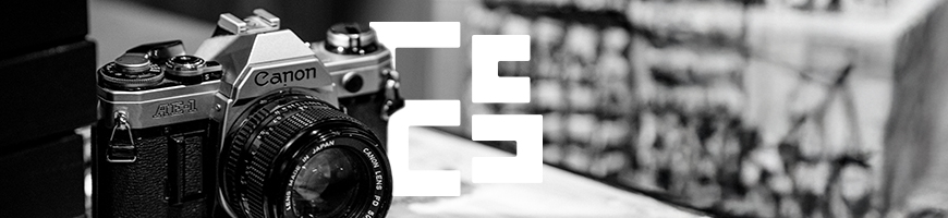 Black and white photo of a camera resting on a table