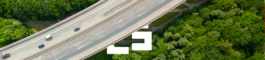 Aerial view of a highway cutting through a lush green forest in Germany.