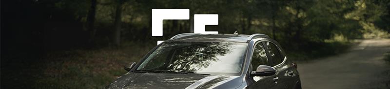 Black car driving down a country lane