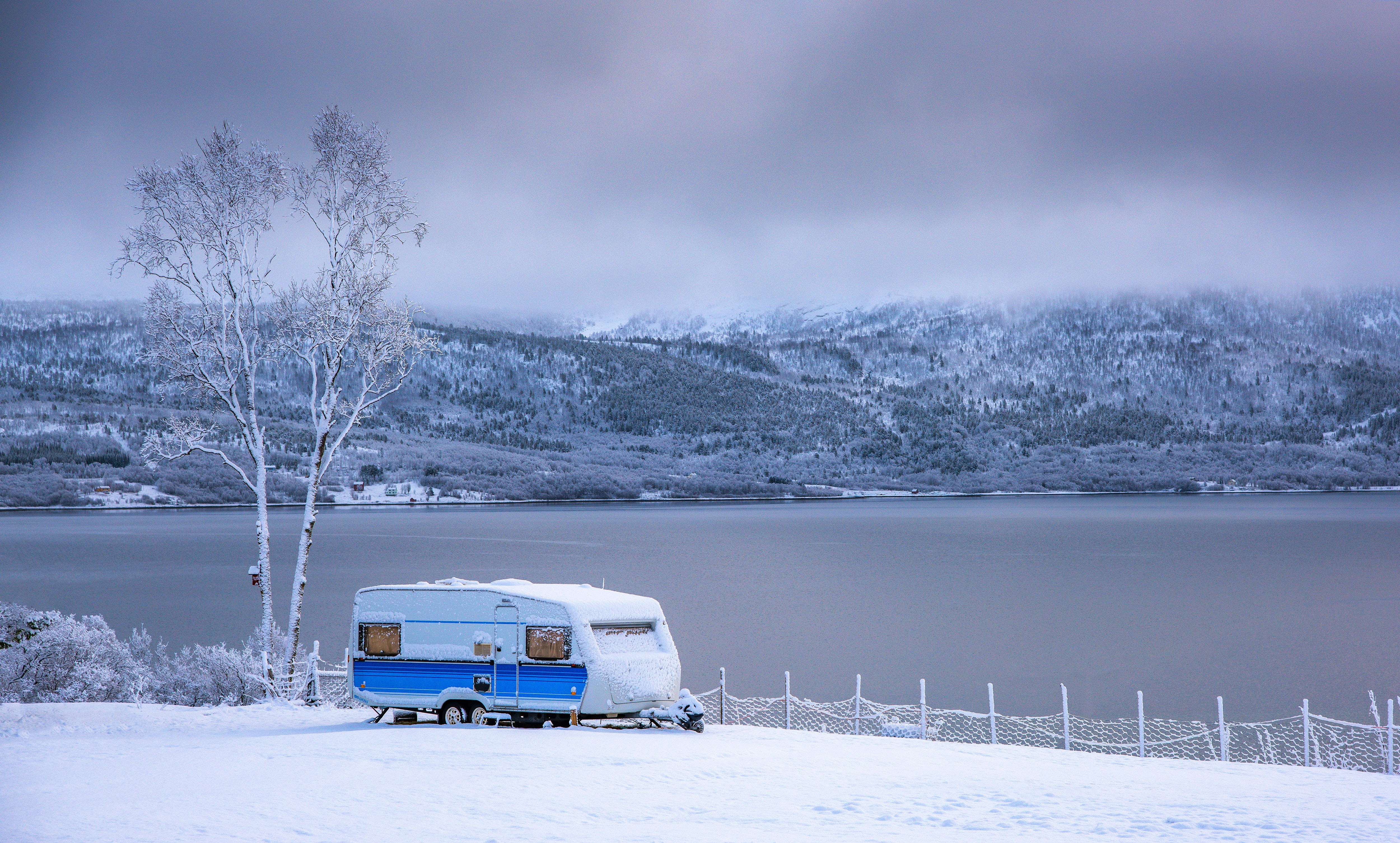Touring caravan with snowy lake scene