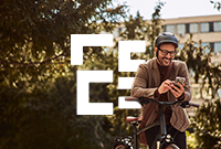 A man riding a bike while holding a phone in his hand