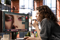 Editing suite with large monitors displaying editing software