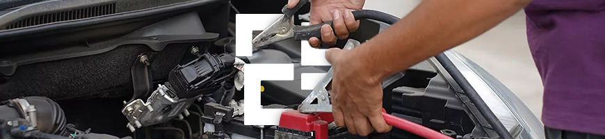 Close-up of hands using jumper cables on a car battery