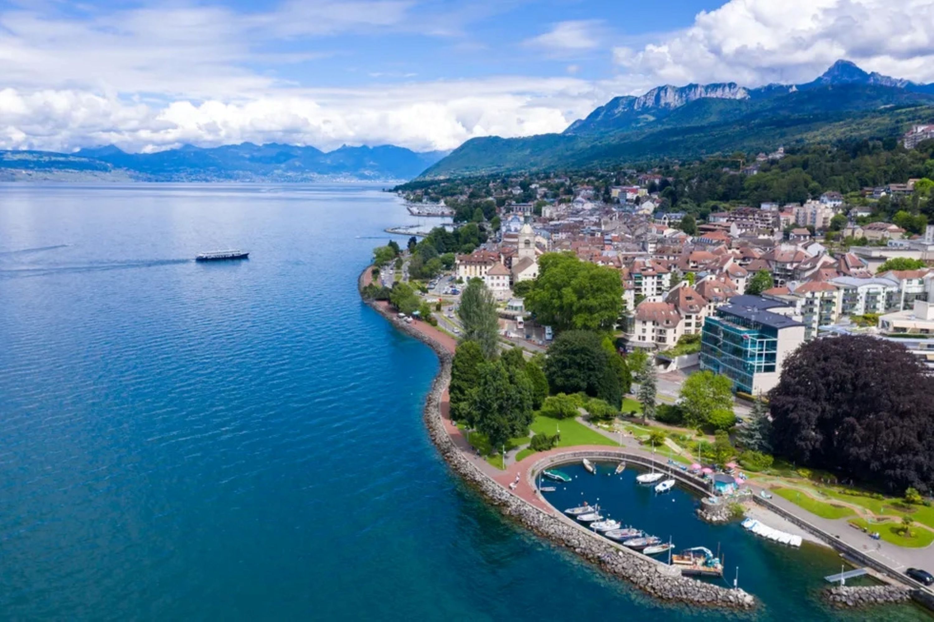 Bird's-eye view of Evian les Bains featuring the cityscape, lake and Alps in the background