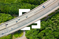 Aerial view of a highway cutting through a lush green forest in Germany.