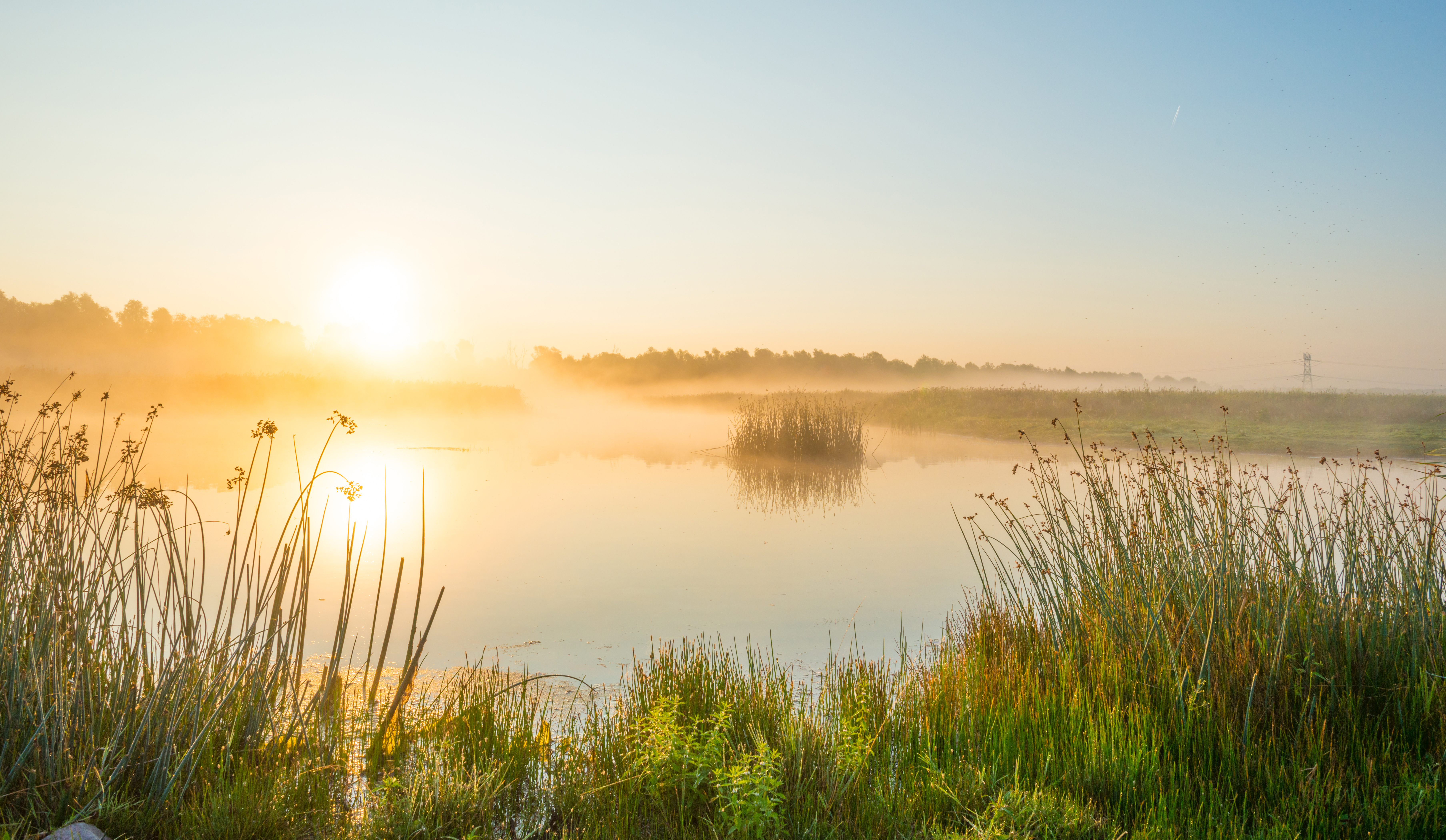 Sunrise over a hazy lake on a summer's day