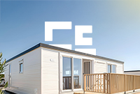 Static caravan under a blue sky on a sunny day