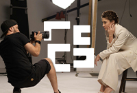 Professional photographer taking photos of model in a studio