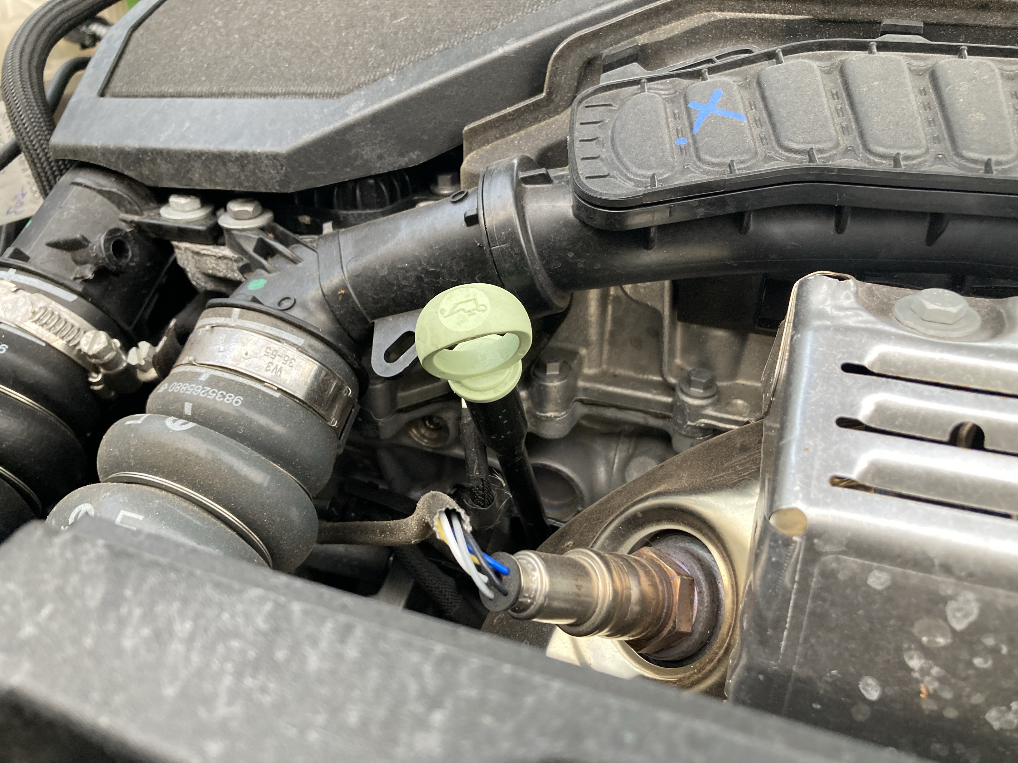Oil reservoir dipstick located underneath car bonnet