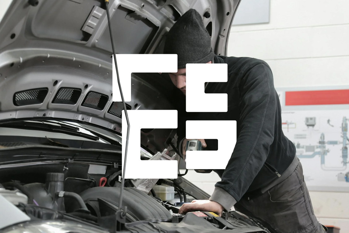 Man inspecting under the bonnet of a car