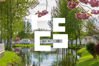 Static caravan park with blossom in view