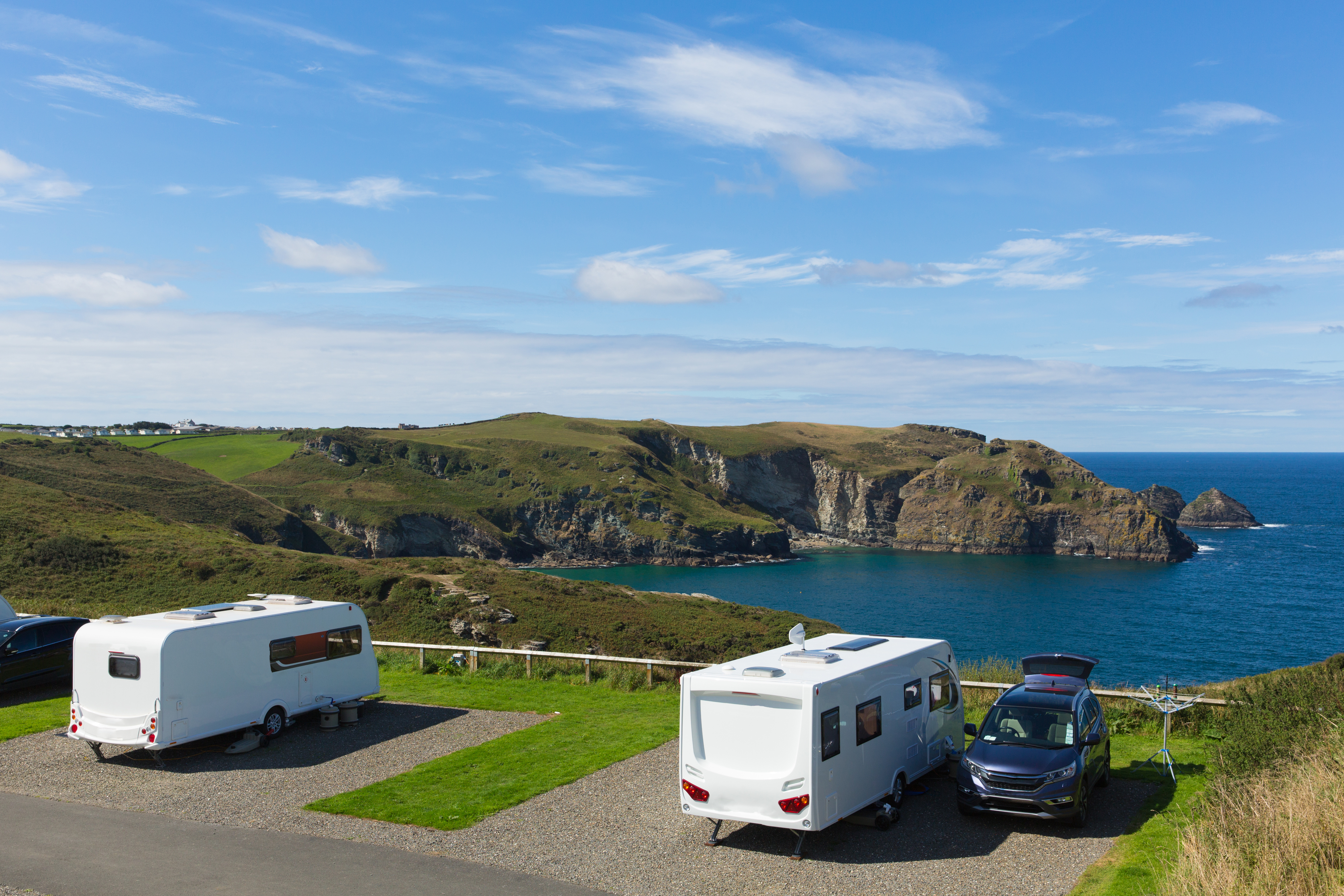 Parked caravans on hillside with view over the sea