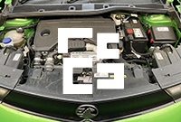 Close up underneath the bonnet of a green car