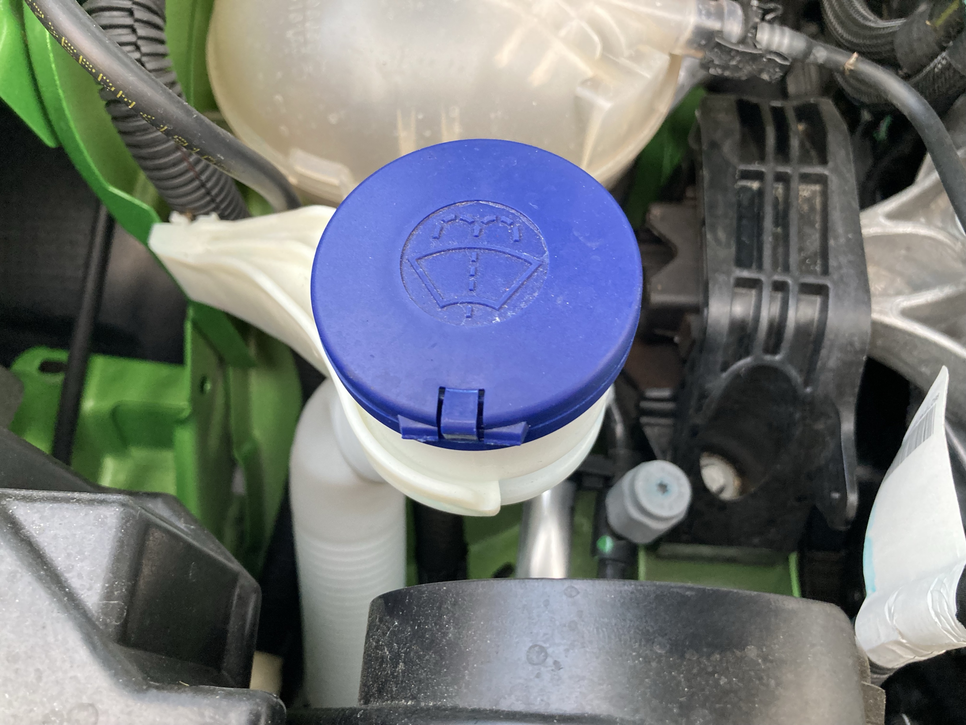 Windscreen washer fluid located underneath car bonnet